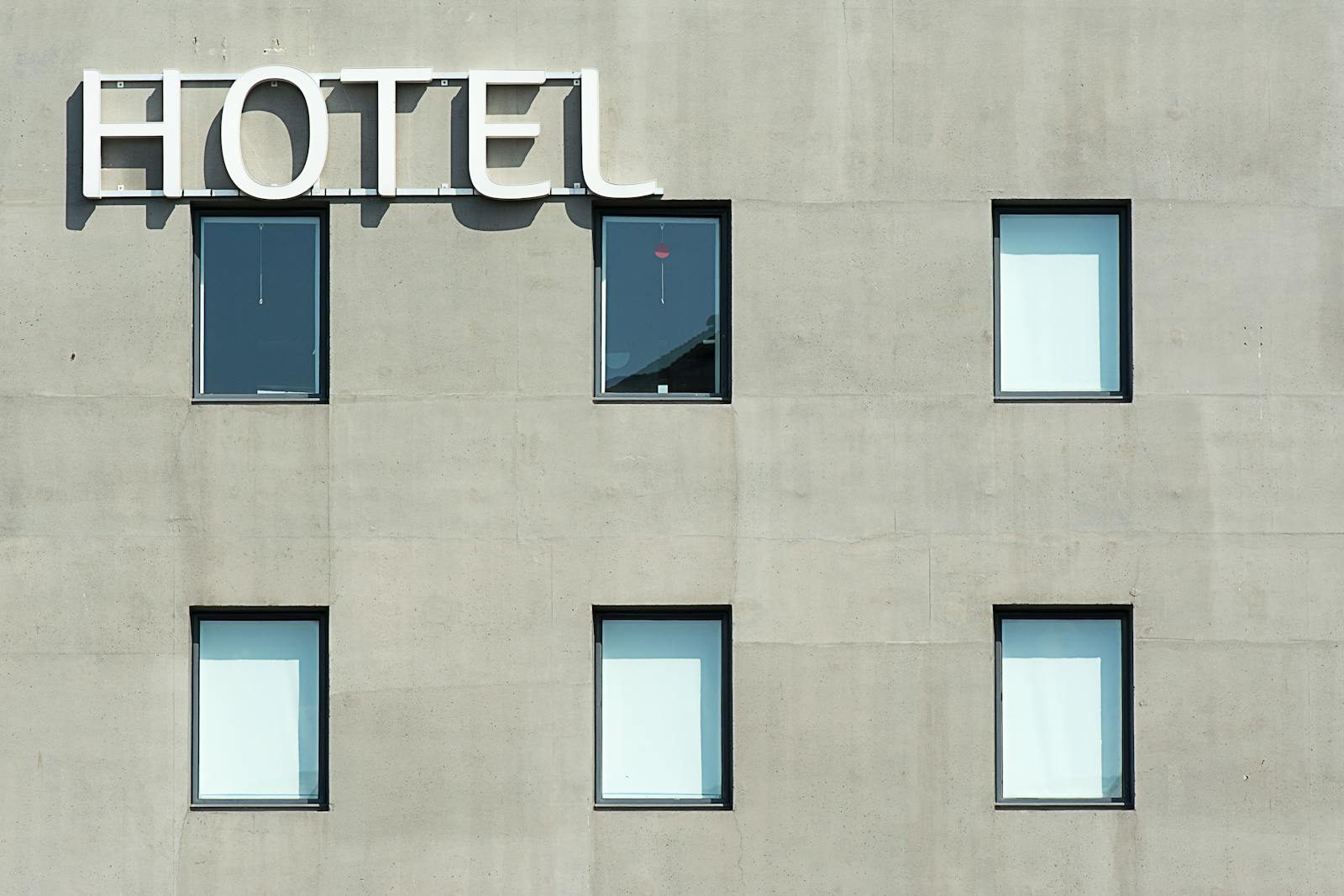 Contemporary hotel facade featuring minimalist design and geometric window patterns.