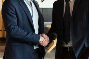 Two business partners shaking hands in agreement.